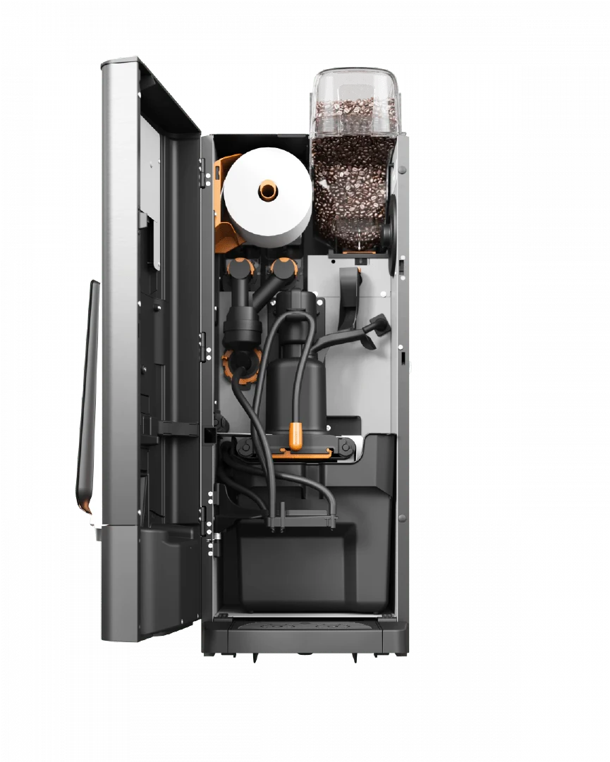 Bildet viser innsiden av en kaffemaskin med synlige komponenter, inkludert rør, en papirrull og en bønnebeholder fylt med kaffebønner.
